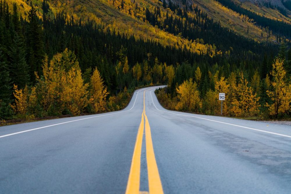 a road with a mountain in the background