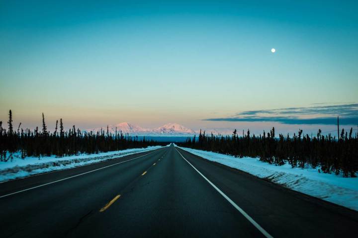 a road with a sunset in the background